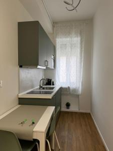 a small kitchen with a sink and a table at Dreaming Ortona in Ortona +23 photos