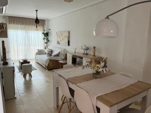 a living room with a table and a couch at Duplex Torre la Sal Magic World La Tormesilla in La Estación