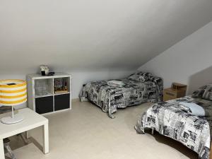 a bedroom with two beds and a table with a table at Duplex Torre la Sal Magic World La Tormesilla in La Estación