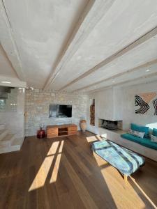 a living room with a couch and a fireplace at Stone House Orsera in Vrsar