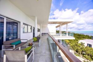 a balcony with chairs and a view of the ocean at Villa Skyline 5 Bedroom stunning Ocean View in Providenciales