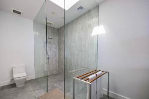 a bathroom with a shower and a toilet at Villa Skyline 5 Bedroom stunning Ocean View in Providenciales