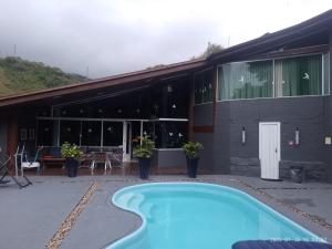 a swimming pool in front of a building at Pousada Morauer in Gaspar Alto