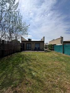 a house with a large yard in front of it at Casa Cielo in San Antonio de Areco