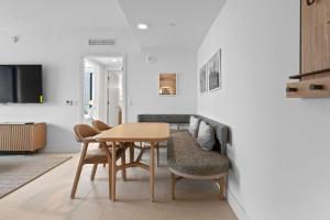 a living room with a dining room table and chairs at Bayside Breeze - Downtown Luxury Tower in Miami