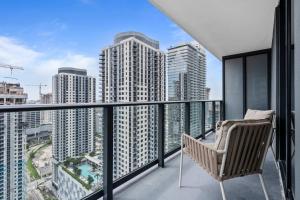 a chair on a balcony with a view of a city at Bayside Breeze - Downtown Luxury Tower in Miami