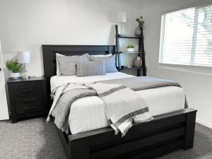 a bedroom with a black and white bed and a window at Casa Ventosa in Hurricane +26 photos
