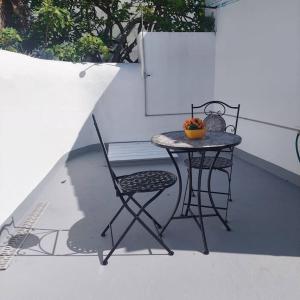 a small table and chair on a patio at Uma horta na Horta in Horta