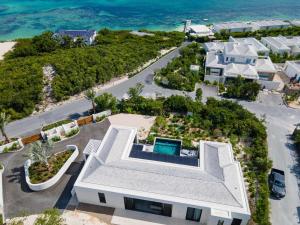 an aerial view of a house on the beach at Villa Pluto 4 Bedroom with Private Pool Oceanfront in Providenciales