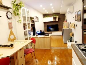 a kitchen and living room with a counter and a refrigerator at Al Cortile in Santa Maria di Licodia