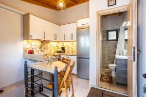 a kitchen with a table and chairs and a toilet at Grande Luxury Villa Kalamata - 3 in Kalamata