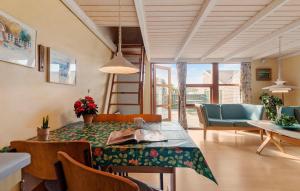 a living room with a dining table and chairs at Gorgeous Apartment In Hemmet With Sauna in Hemmet
