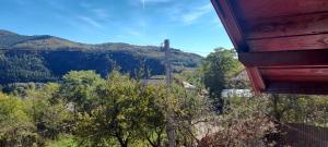 a view of a mountain valley with a ski lift at Casa linistita Ilie in Păltineni