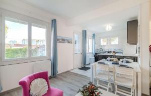 a kitchen and dining room with a table and chairs at Stunning Home In Royan With Wifi in Royan