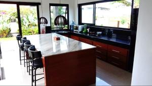 a kitchen with a large island with a counter top at Villa Limun in Ujung