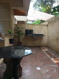 a stone patio with a table and a sink at Apartamento perto da Orla em frente ao Beira Rio in Porto Alegre