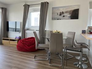a living room with a table and chairs and a television at Highrise in Shoreditch in London