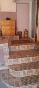 a room with a bed and a wooden dresser at Casa linistita Ilie in Păltineni +30 photos