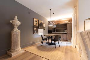 a dining room with a table and chairs in a room at Iseo Escape - Charm Studio in the Heart of the City in Iseo +38 photos
