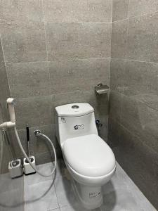 a bathroom with a white toilet in a stall at غرفة مريحة بوسط جدة in Jeddah +2 photos