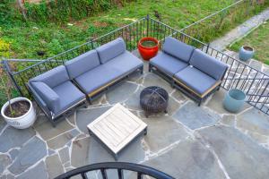 two blue couches sitting on a patio with a table at 12ppl House in NW BBQ & Fire Pit in Washington
