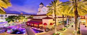 a large building with a clock tower and palm trees at New Construction Home 10 To Beach 5 To Downtown in West Palm Beach