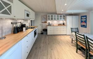 a kitchen with white cabinets and a table in a room at 4 Bedroom Gorgeous Home In Bagn in Bagn