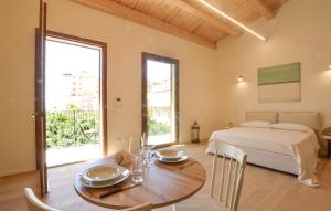 a bedroom with a bed and a table with a dining room at Lovely Apartment In Realmonte in Realmonte