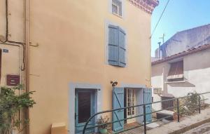 an old building with blue doors and a staircase at Amazing Home In Cessenon-Sur-Orb in Cessenon +13 photos