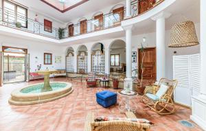 a large living room with a fountain in the middle at Beautiful Home In Saint-Cyr-Sur-Loire in Saint-Cyr-sur-Loire