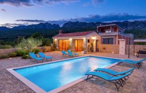 a swimming pool with chairs and a house at Pet Friendly Home In Seline With Sauna in Seline