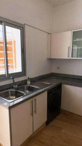 a small kitchen with a sink and a dishwasher at Villa - Royal Golf de Fez - Pool in Fez +18 photos