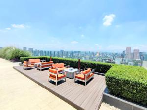 a group of chairs and tables on a wooden deck at Luxury Polanco Apartment With Private Balcony in Mexico City