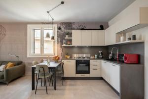 a kitchen with a table and a dining room at Apartment Il Giglio in Montelupo Fiorentino