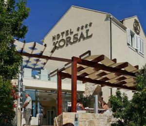 
a large building with a sign on the front of it at Hotel Korsal in Korčula

