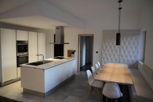 cocina y comedor con mesa y sillas en Ard'cube, en Noiseux