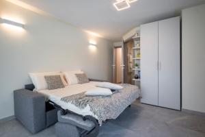 a bedroom with a bed and a white cabinet at Apartment Il Giglio in Montelupo Fiorentino
