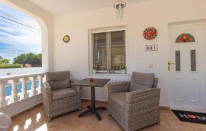 a porch with two chairs and a table and a window at 3 Bedroom Beautiful Home In Rojales in Rojales