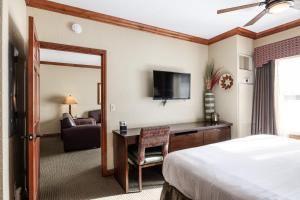 a hotel room with a bed and a desk and a television at Westgate Resort- 1 BR, Resort Amenities, Shopping and Restaurants! in Park City +34 photos