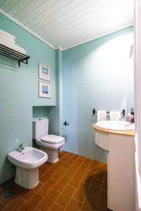 a bathroom with a white toilet and a sink at Casa Maria Amalia in Cascais +17 photos
