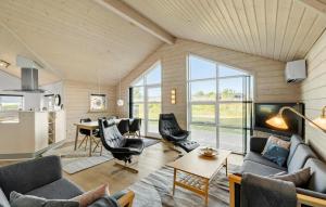 a living room with a couch and chairs and a table at Amazing Home In Tarm With Sauna in Tarm