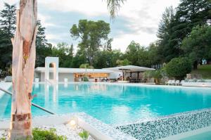 a large swimming pool with a building in the background at Parque Hotel in Villa Carlos Paz