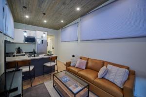 a living room with a couch and a kitchen at Red Rock RV Park in Island Park