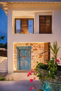 a house with a blue door on the side of it at Villa Aura Heated Pool&Jacuzzi near Albena in Rogachevo
