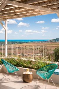 a patio with two chairs and a view of the ocean at Villa Aura Heated Pool&Jacuzzi near Albena in Rogachevo