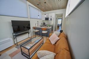 a living room with a couch and a kitchen at Red Rock RV Park in Island Park