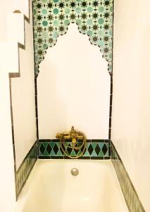 a bathroom with a bath tub with a mirror at Historic Casa Almelara with Heated Pool and Steam Room in Atalbéitar