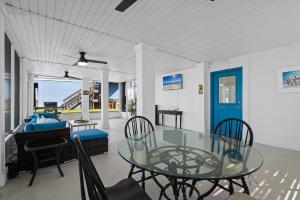a dining room with a glass table and chairs at Seas The Day in Navarre