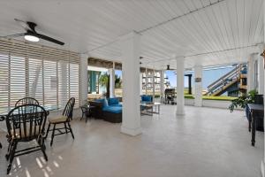a living room with a couch and a table and chairs at Seas The Day in Navarre