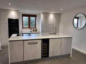 a kitchen with a sink and a counter top at Oak Barn-ideal for Nec,Hs2,BHX,family gatherings in Birmingham +31 photos
